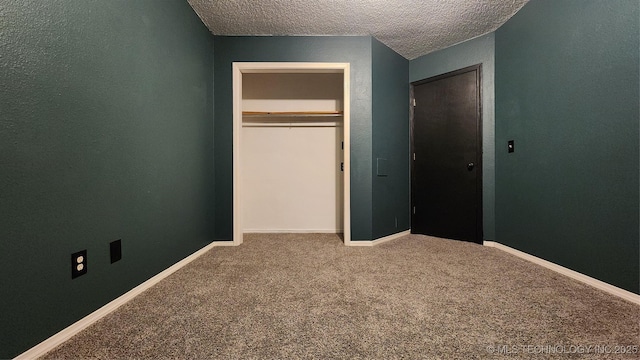 305 E 48th Pl, Sand Springs, OK 74063 - unfurnished bedroom featuring a closet, baseboards, a textured wall, a textured ceiling, and carpet floors