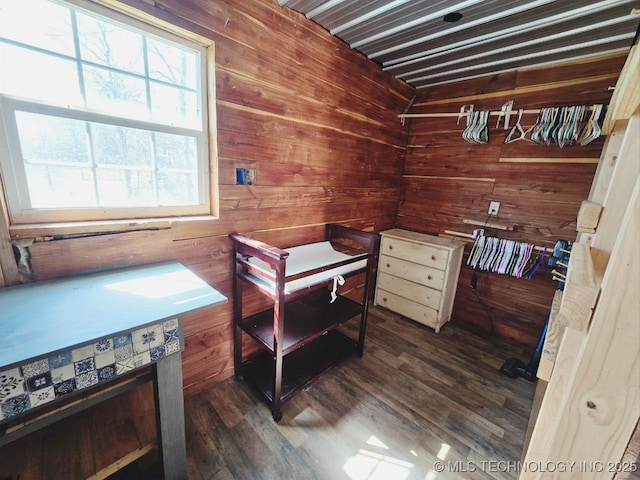 020 Haworth, Durant, OK 74701 - bedroom with wooden walls and dark wood-style flooring