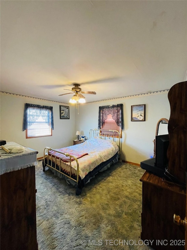 306 N Cherokee St, Beggs, OK 74421 - bedroom featuring a ceiling fan, baseboards, and dark colored carpet