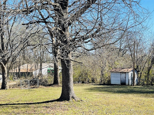 306 N Cherokee St, Beggs, OK 74421 - view of yard with an outbuilding, a shed, and fence