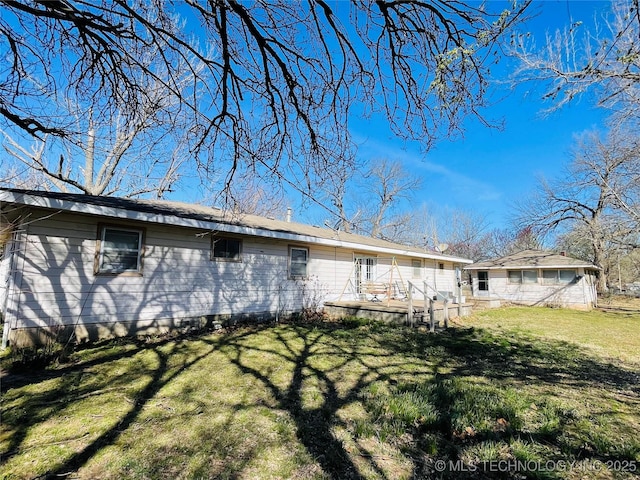 306 N Cherokee St, Beggs, OK 74421 - back of house featuring a deck and a yard