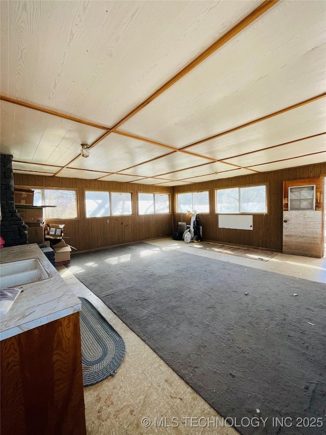 306 N Cherokee St, Beggs, OK 74421 - interior space featuring multiple windows, wood walls, carpet floors, and a sink
