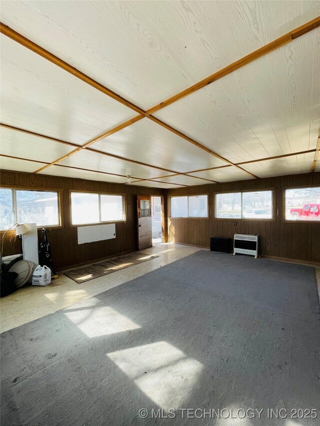 306 N Cherokee St, Beggs, OK 74421 - interior space with heating unit, wood walls, and carpet flooring