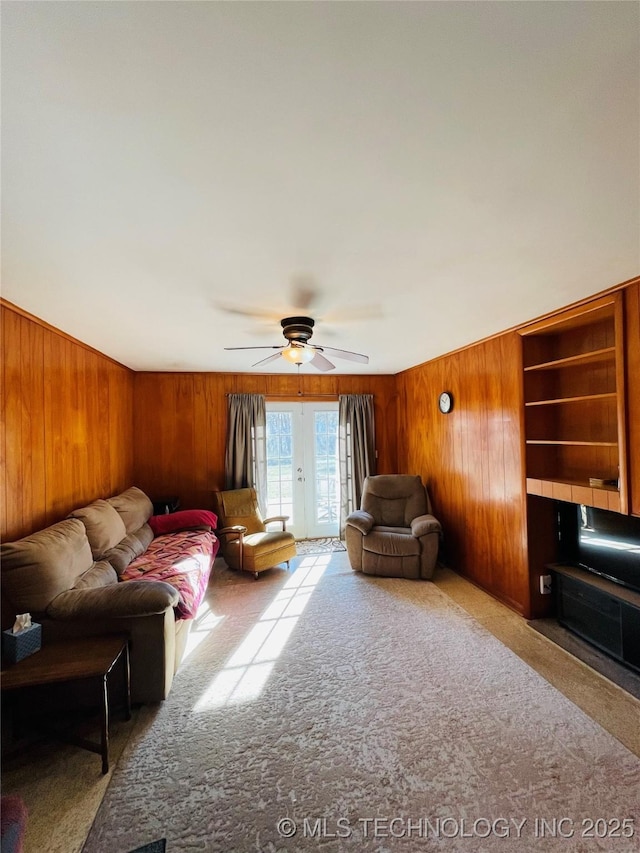 306 N Cherokee St, Beggs, OK 74421 - carpeted living room featuring wooden walls and ceiling fan