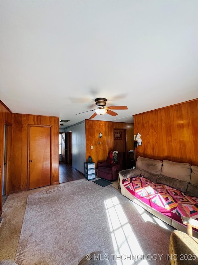 306 N Cherokee St, Beggs, OK 74421 - unfurnished bedroom featuring wooden walls, ceiling fan, and carpet flooring