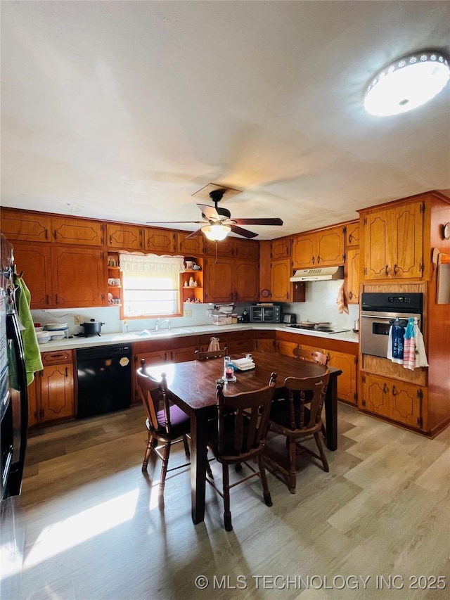 306 N Cherokee St, Beggs, OK 74421 - kitchen with oven, under cabinet range hood, black dishwasher, brown cabinetry, and white cooktop