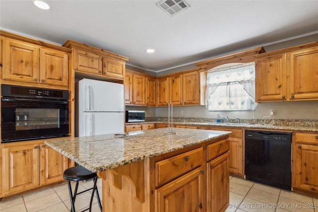 5690 E 570th Rd, Rose, OK 74364 - kitchen featuring visible vents, black appliances, a sink, light stone counters, and a center island