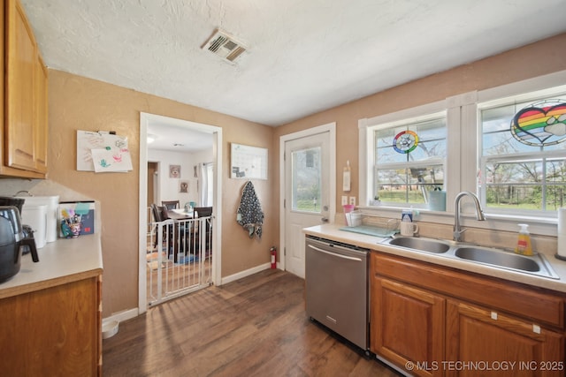 302 W 4th St, Skiatook, OK 74070 - kitchen featuring visible vents, dishwasher, light countertops, dark wood-style floors, and a sink