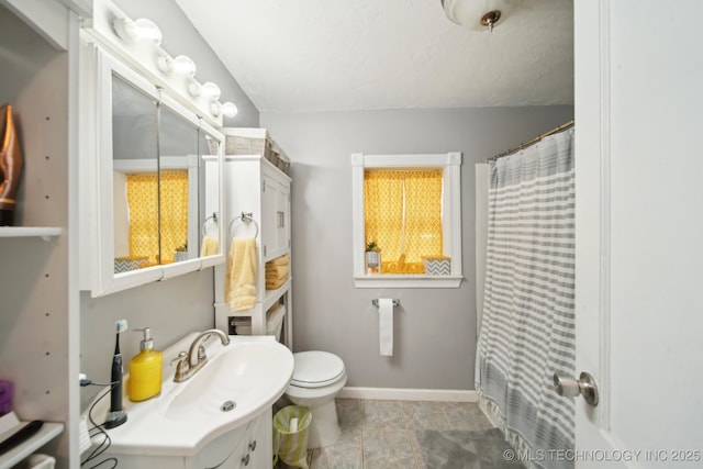 302 W 4th St, Skiatook, OK 74070 - bathroom featuring vanity, a shower with shower curtain, toilet, and baseboards