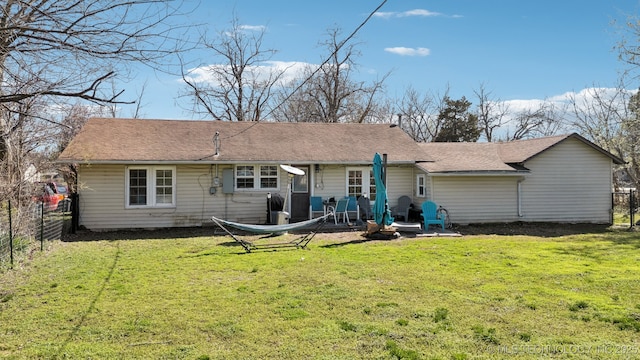 302 W 4th St, Skiatook, OK 74070 - rear view of property featuring a patio area, a lawn, a shingled roof, and a fenced backyard