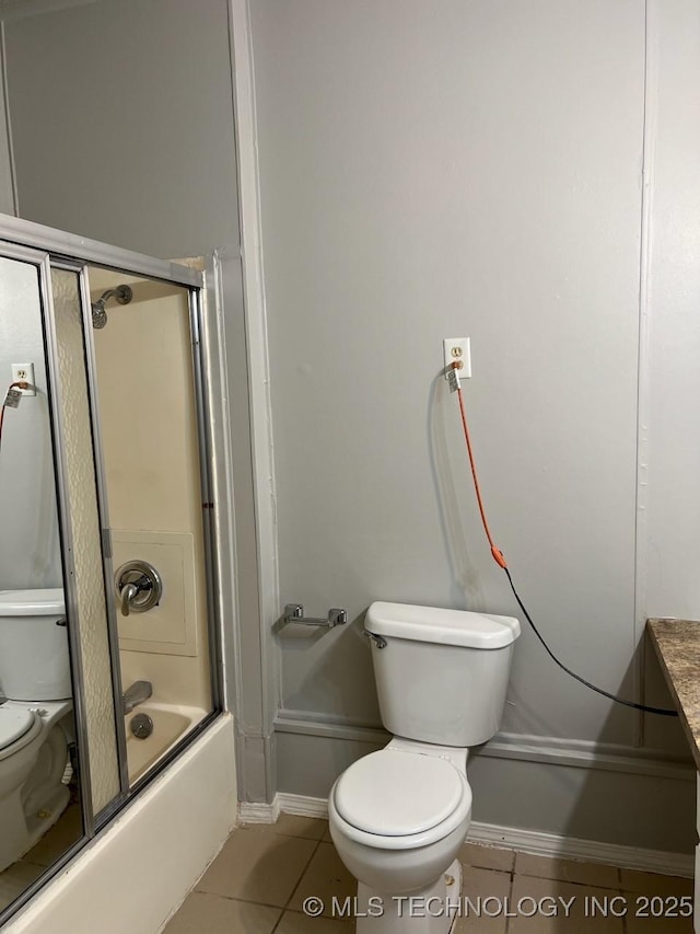 12802 E 31st Ct, Tulsa, OK 74146 - full bathroom with tile patterned floors, baseboards, toilet, and combined bath / shower with glass door