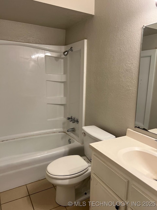 12802 E 31st Ct, Tulsa, OK 74146 - bathroom featuring tile patterned flooring, tub / shower combination, toilet, a textured wall, and vanity