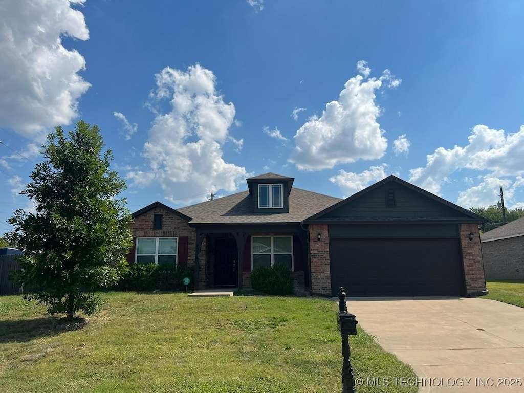 2035 N Kenosha Ct E, Tulsa, OK 74106 - ranch-style home featuring roof with shingles, concrete driveway, a front lawn, a garage, and brick siding