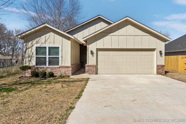 view of front of home featuring fence, driveway, brick siding, a garage, and board and batten siding