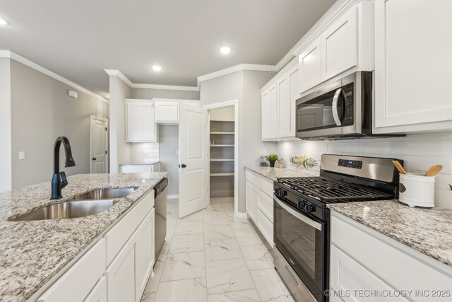 kitchen with a sink, stainless steel appliances, marble finish floor, and decorative backsplash