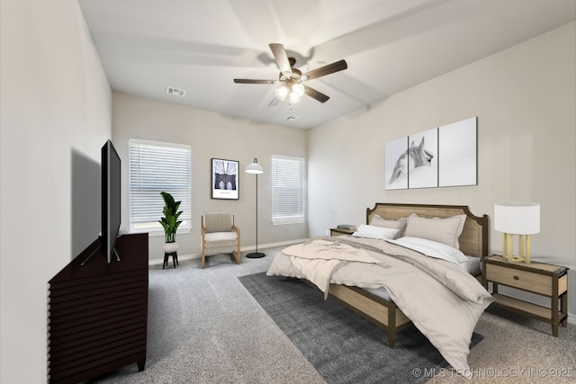 carpeted bedroom featuring visible vents, baseboards, and ceiling fan