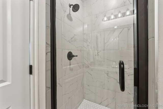 bathroom with a marble finish shower