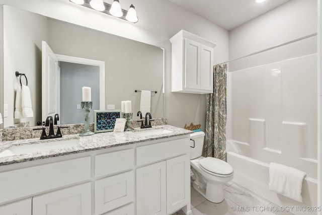 full bathroom with toilet, marble finish floor, a sink, shower / bath combination with curtain, and double vanity