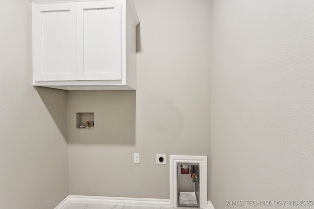 laundry room with baseboards, cabinet space, hookup for an electric dryer, and hookup for a washing machine