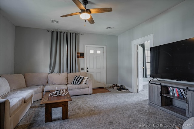 carpeted living room with visible vents and ceiling fan