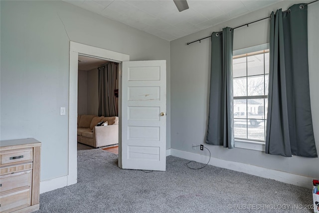 unfurnished bedroom with ceiling fan, baseboards, and carpet floors