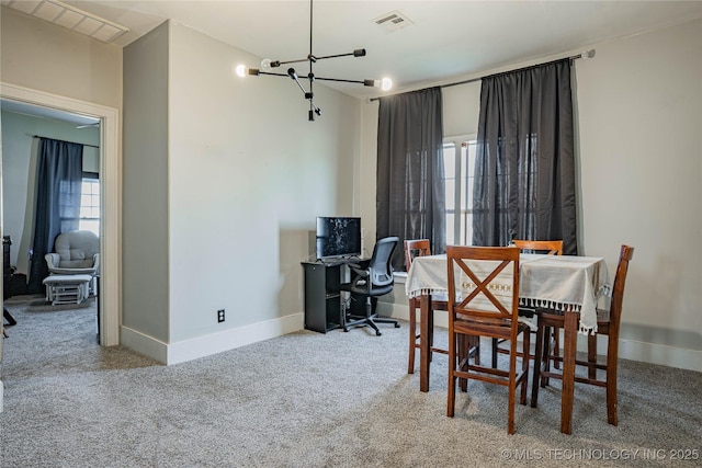 carpeted dining room with visible vents, baseboards, and an inviting chandelier