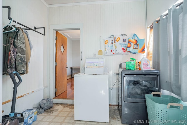 clothes washing area featuring laundry area, separate washer and dryer, and tile patterned floors