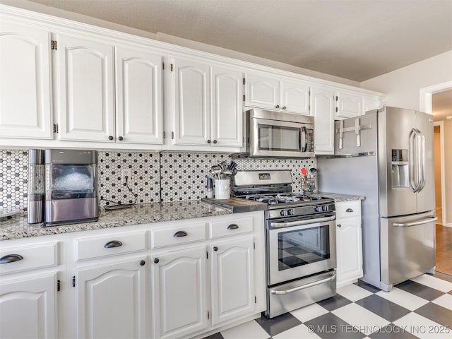 7610 N 127th E Ave, Owasso, OK 74055 - kitchen featuring stainless steel appliances, light floors, white cabinets, and backsplash