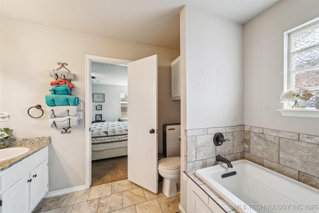 7610 N 127th E Ave, Owasso, OK 74055 - ensuite bathroom featuring toilet, a garden tub, vanity, and tile patterned floors