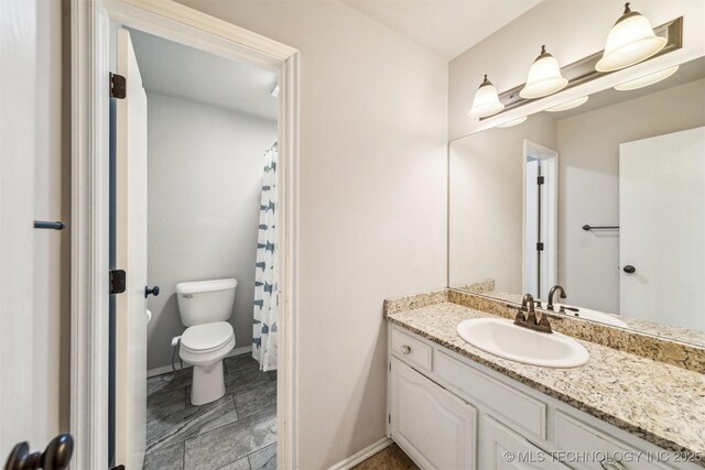 7610 N 127th E Ave, Owasso, OK 74055 - bathroom with toilet, vanity, and baseboards
