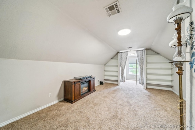 7610 N 127th E Ave, Owasso, OK 74055 - bonus room with light carpet, lofted ceiling, and baseboards