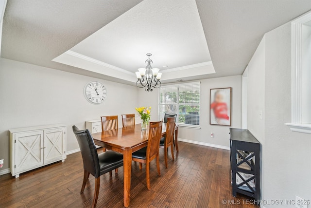 7610 N 127th E Ave, Owasso, OK 74055 - dining room with a tray ceiling, a chandelier, dark wood finished floors, baseboards, and ornamental molding