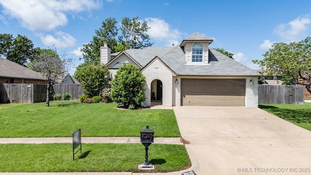 7610 N 127th E Ave, Owasso, OK 74055 - view of front of house with brick siding, concrete driveway, a chimney, and an attached garage