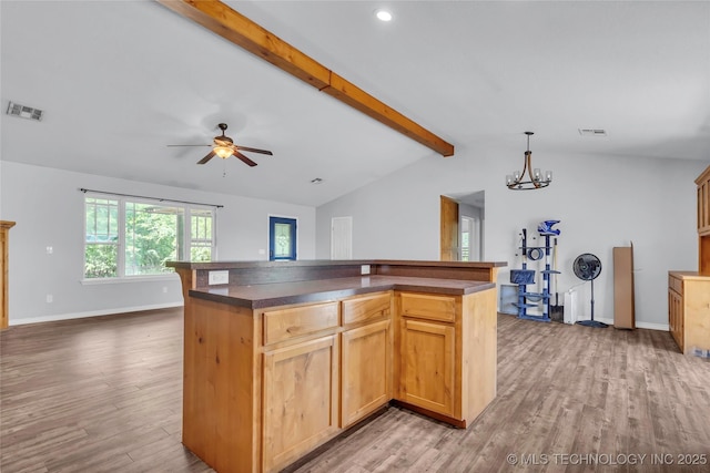 922 Oak Ridge St, Ardmore, OK 73401 - kitchen with dark countertops, light wood-style flooring, a chandelier, a kitchen island, and ceiling fan