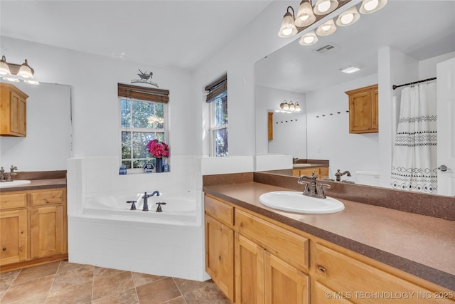 922 Oak Ridge St, Ardmore, OK 73401 - bathroom featuring two vanities, a garden tub, and toilet