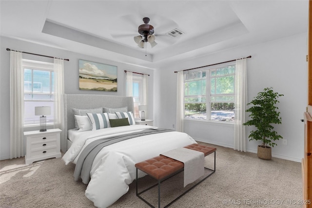 922 Oak Ridge St, Ardmore, OK 73401 - bedroom featuring a tray ceiling, carpet flooring, baseboards, and ceiling fan