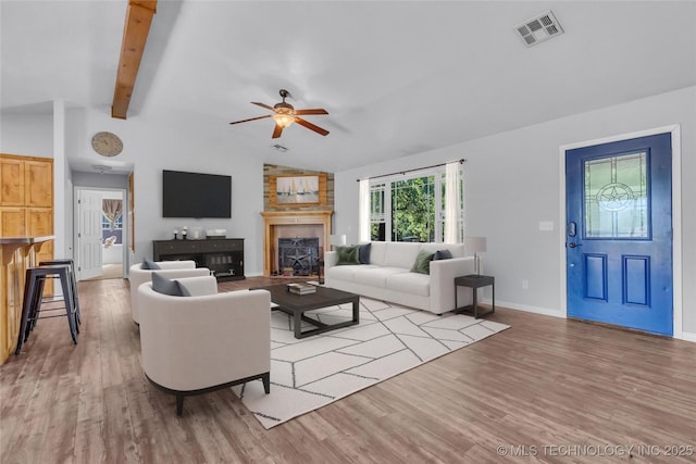 922 Oak Ridge St, Ardmore, OK 73401 - living room with wood finished floors, ceiling fan, and a fireplace