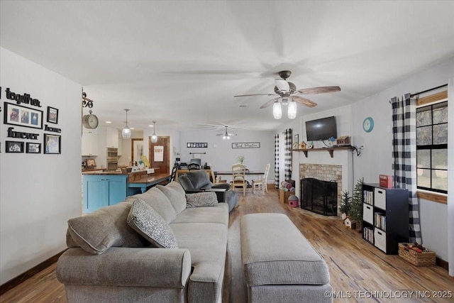 420722 E 1920th Rd, Antlers, OK 74523 - living room featuring a fireplace, wood finished floors, baseboards, and ceiling fan