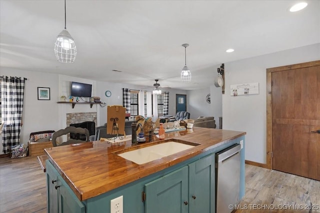 420722 E 1920th Rd, Antlers, OK 74523 - kitchen featuring butcher block countertops, open floor plan, dishwasher, and a sink