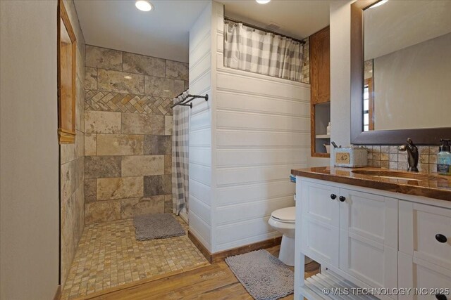 420722 E 1920th Rd, Antlers, OK 74523 - full bathroom featuring vanity, toilet, wood finished floors, and tiled shower