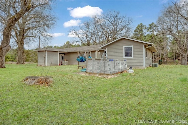 420722 E 1920th Rd, Antlers, OK 74523 - rear view of house featuring a yard, an outdoor pool, and central AC