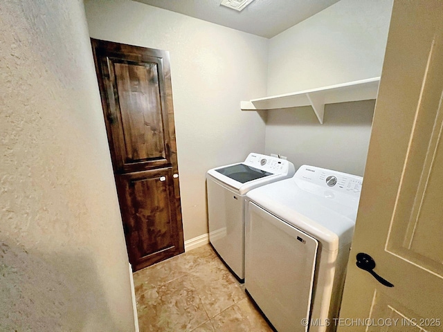 4169 Highland Dr, Tahlequah, OK 74464 - washroom with washer and clothes dryer, a textured wall, and light tile patterned floors