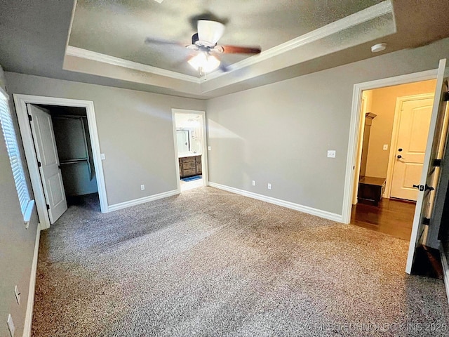 4169 Highland Dr, Tahlequah, OK 74464 - unfurnished bedroom with a raised ceiling, carpet floors, crown molding, baseboards, and a spacious closet