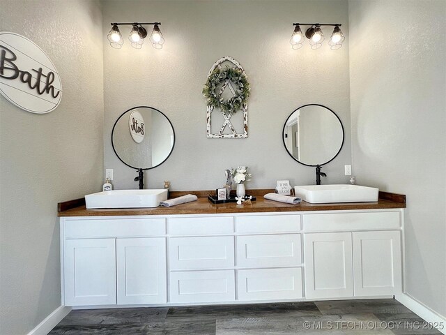 11457 N 510th Rd, Tahlequah, OK 74464 - bathroom with wood finished floors, double vanity, and baseboards