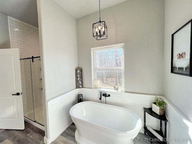 11457 N 510th Rd, Tahlequah, OK 74464 - bathroom featuring a soaking tub, wood finished floors, a shower stall, a chandelier, and wainscoting