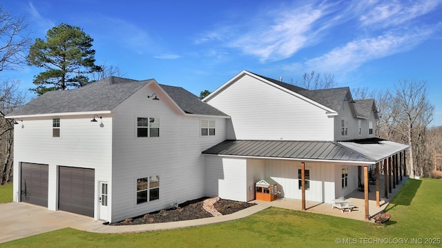 11457 N 510th Rd, Tahlequah, OK 74464 - back of house with a garage, a lawn, driveway, a patio, and board and batten siding