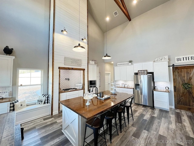 11457 N 510th Rd, Tahlequah, OK 74464 - kitchen with high vaulted ceiling, stainless steel appliances, decorative backsplash, white cabinets, and dark wood-type flooring