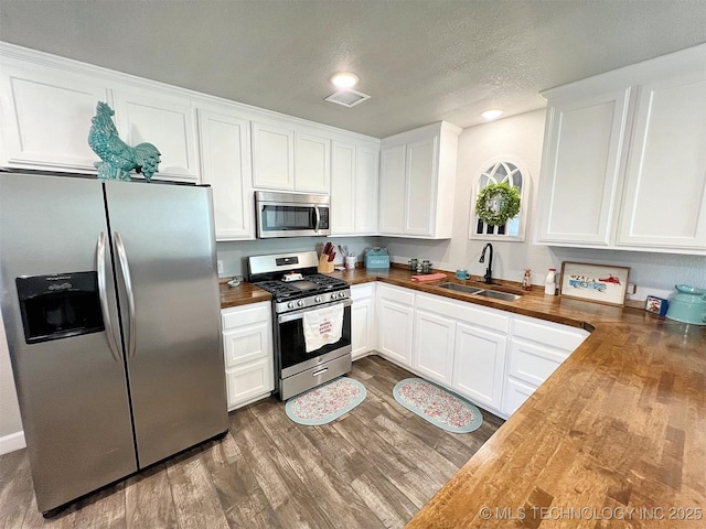 11457 N 510th Rd, Tahlequah, OK 74464 - kitchen with appliances with stainless steel finishes, a sink, wood counters, and dark wood-style flooring