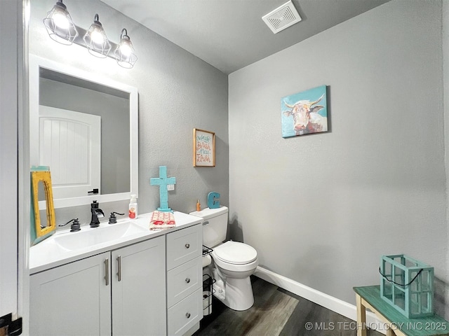 11457 N 510th Rd, Tahlequah, OK 74464 - bathroom featuring wood finished floors, toilet, vanity, and baseboards