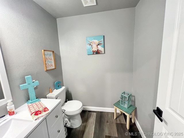 11457 N 510th Rd, Tahlequah, OK 74464 - half bath featuring toilet, wood finished floors, vanity, and baseboards